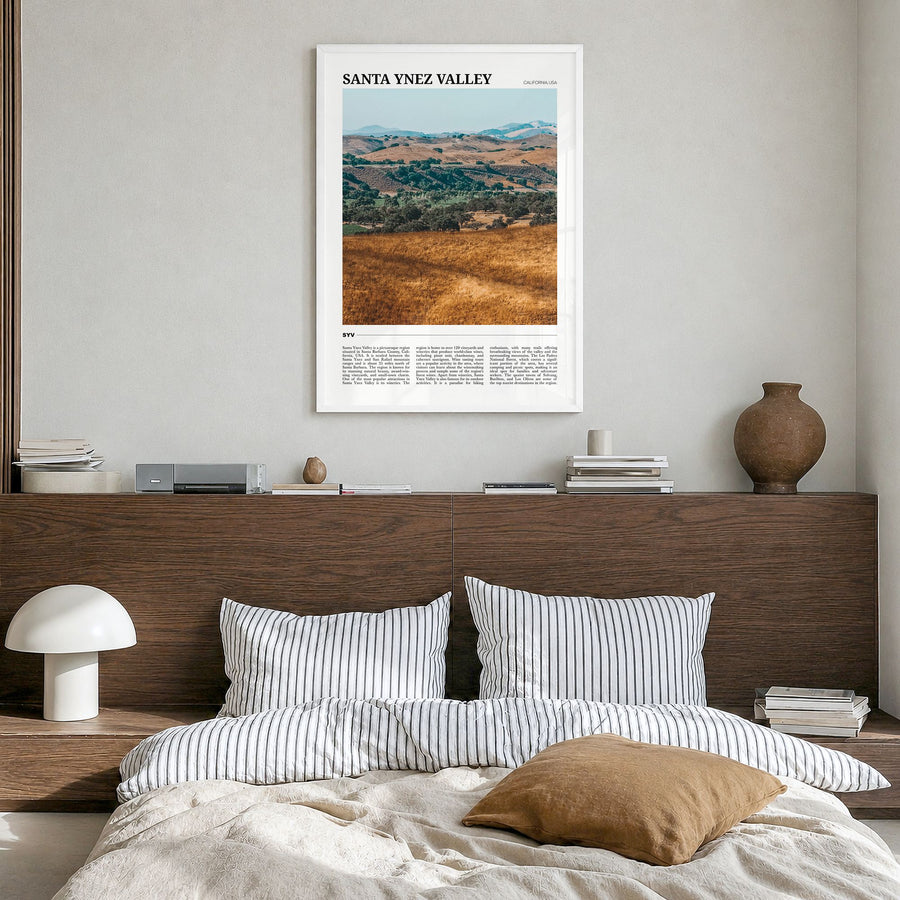 Santa Ynez Valley Travel Poster in a white wood frame, hanging in a bedroom