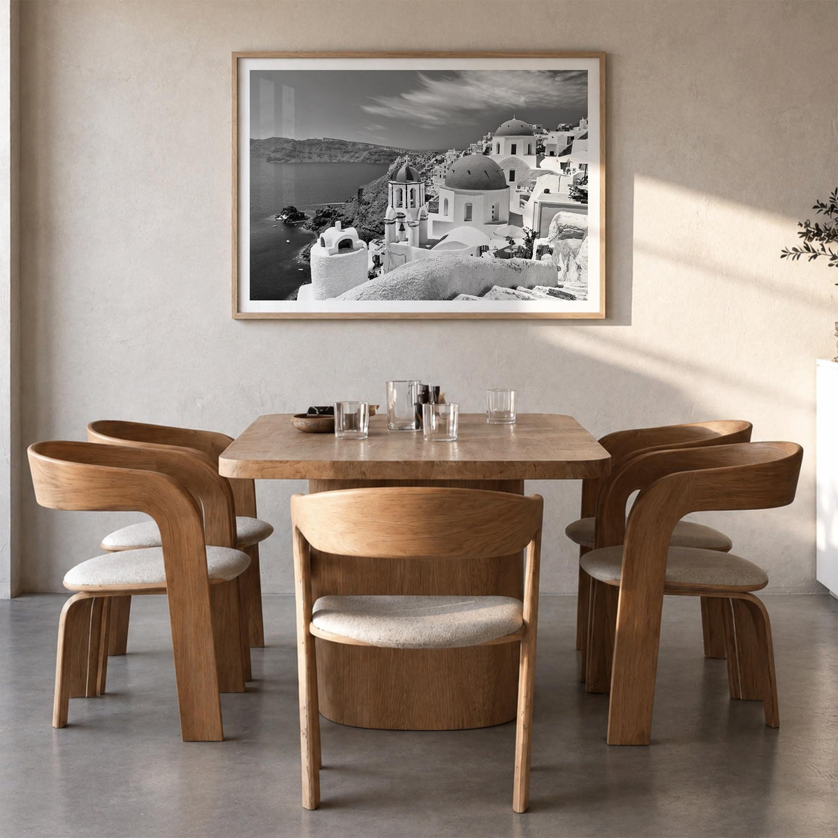 Santorini black & white photo poster of Greece – horizontal wall art in natural wood frame with white border, hanging on wall