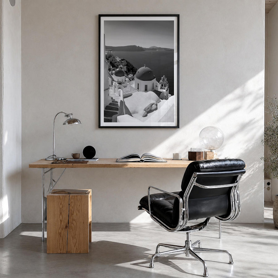 Santorini no. 2 black & white photo poster of Greece – vertical wall art in black wood frame with white border, hanging on wa