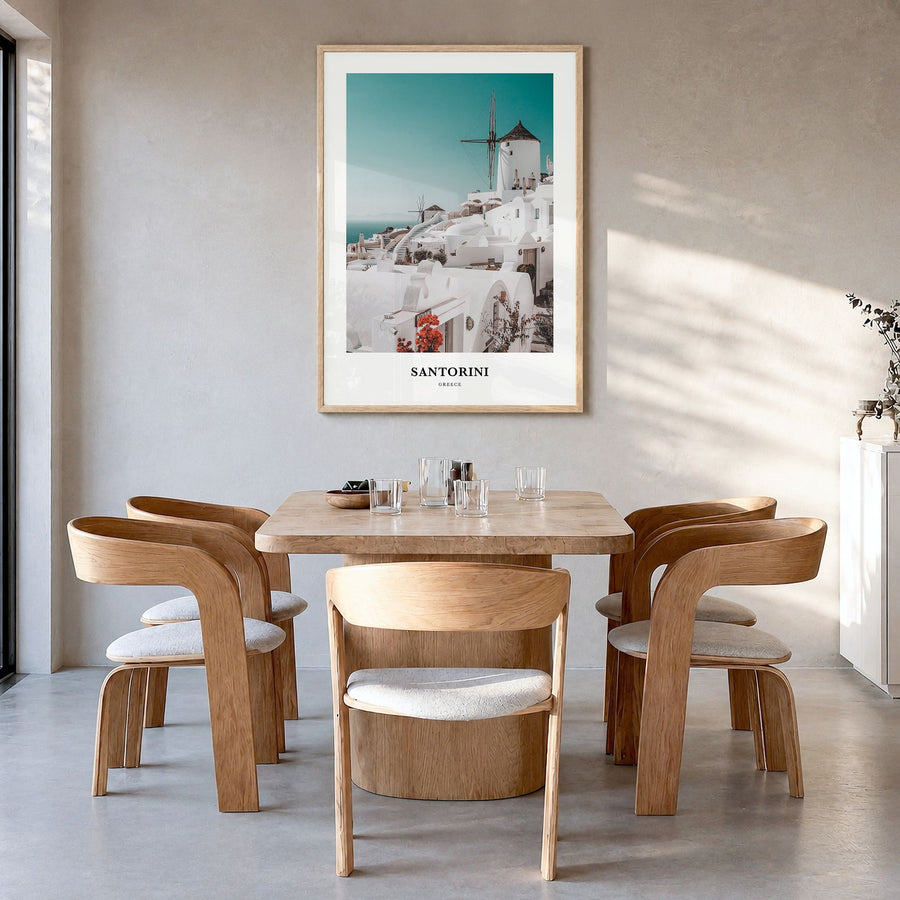 Santorini Classic Poster in a natural wood frame, hanging in a dining room