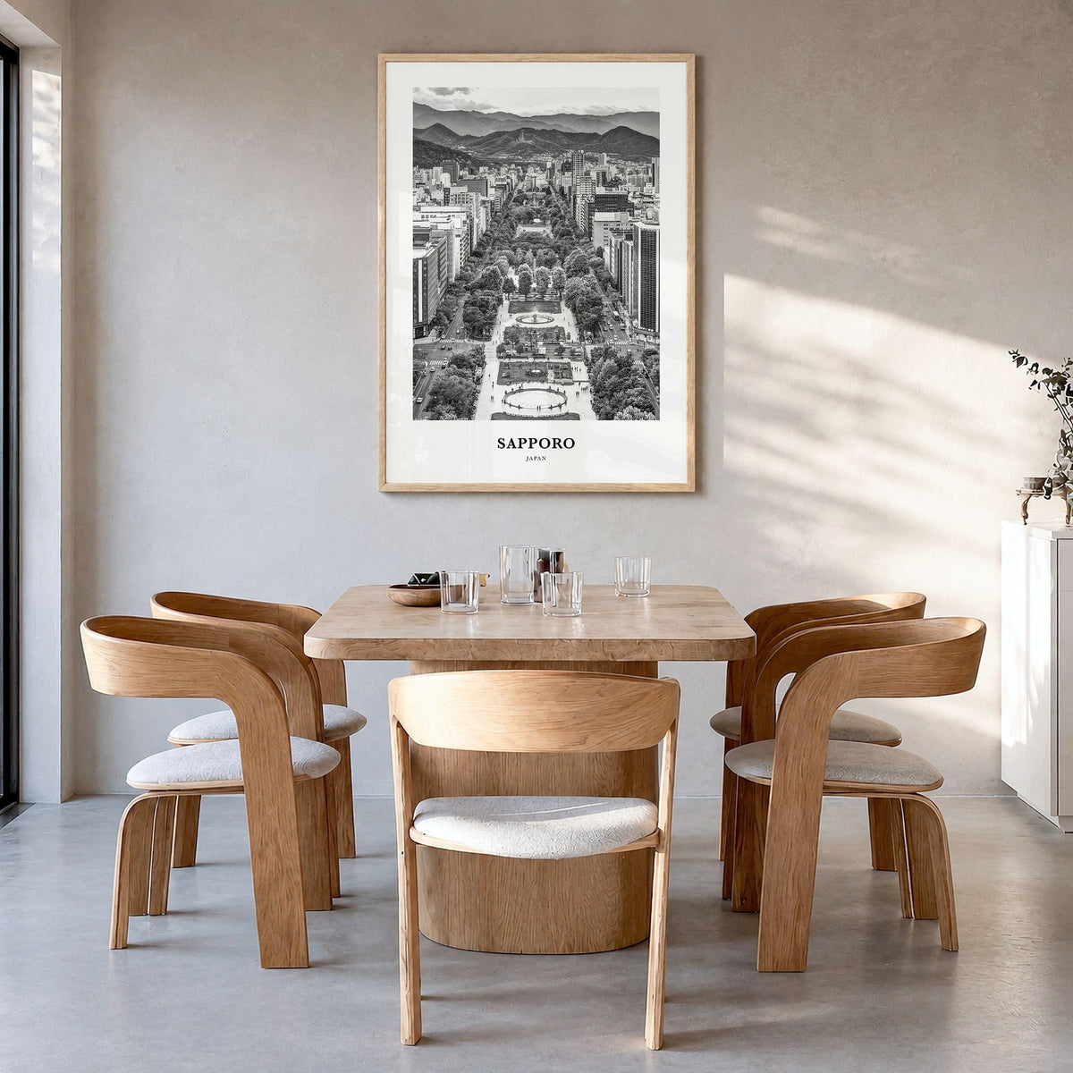 Sapporo Classic Poster in a natural wood frame, hanging in a dining room