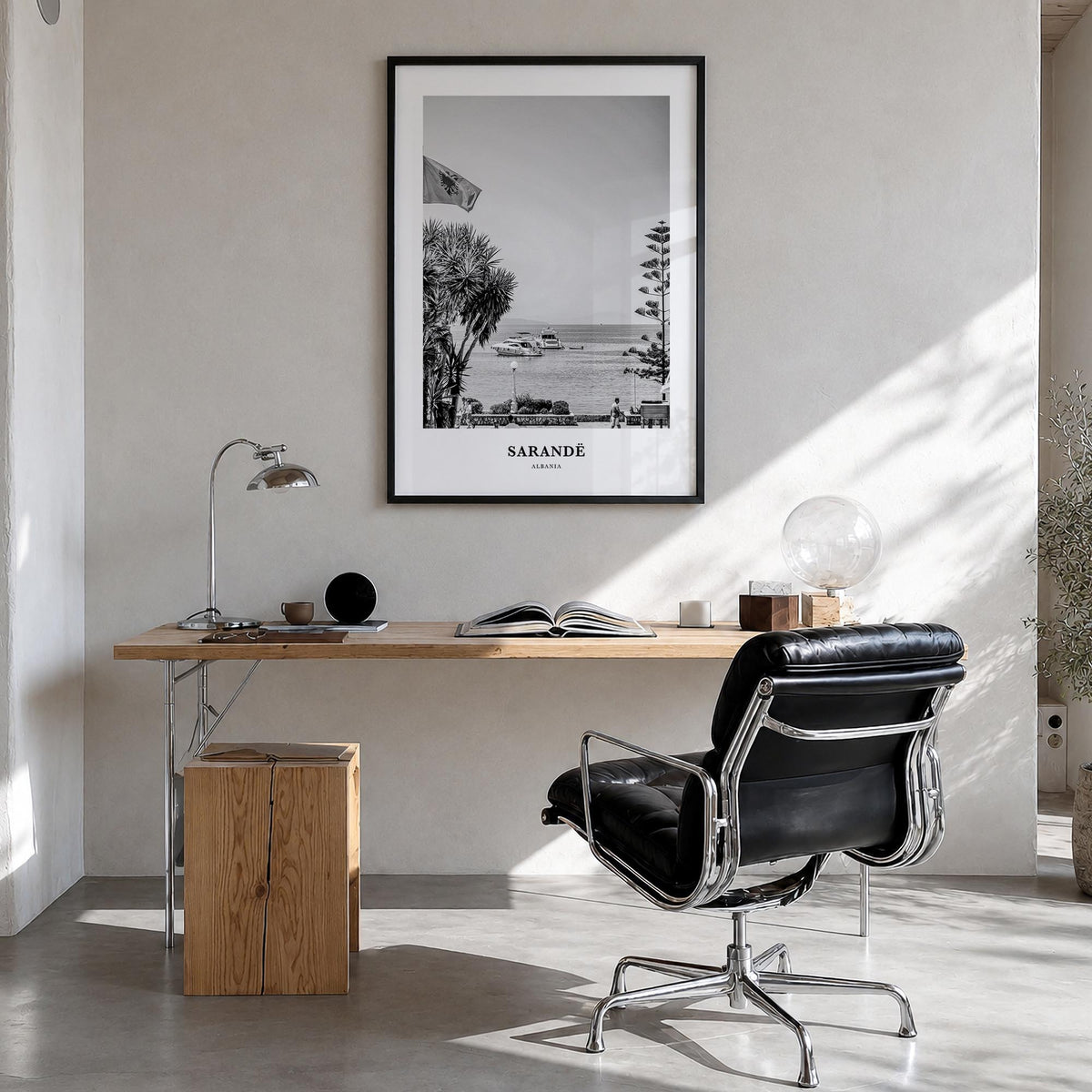 Sarandë black & white classic poster of Albania – vertical wall art in black wood frame, hanging on wall