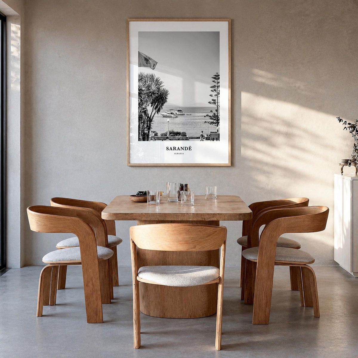 Sarandë black & white classic poster of Albania – vertical wall art in natural wood frame, hanging on wall