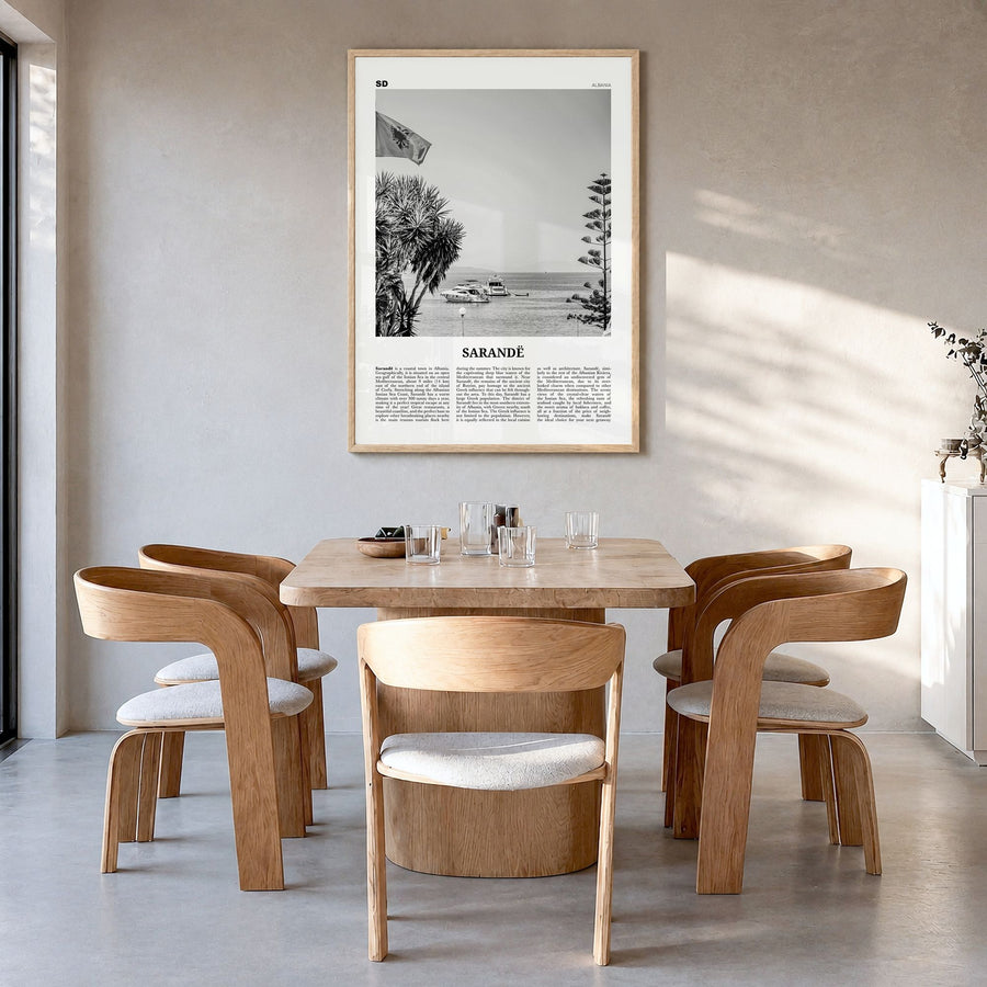 Sarandë Newspaper Poster in a natural wood frame, hanging in a dining room