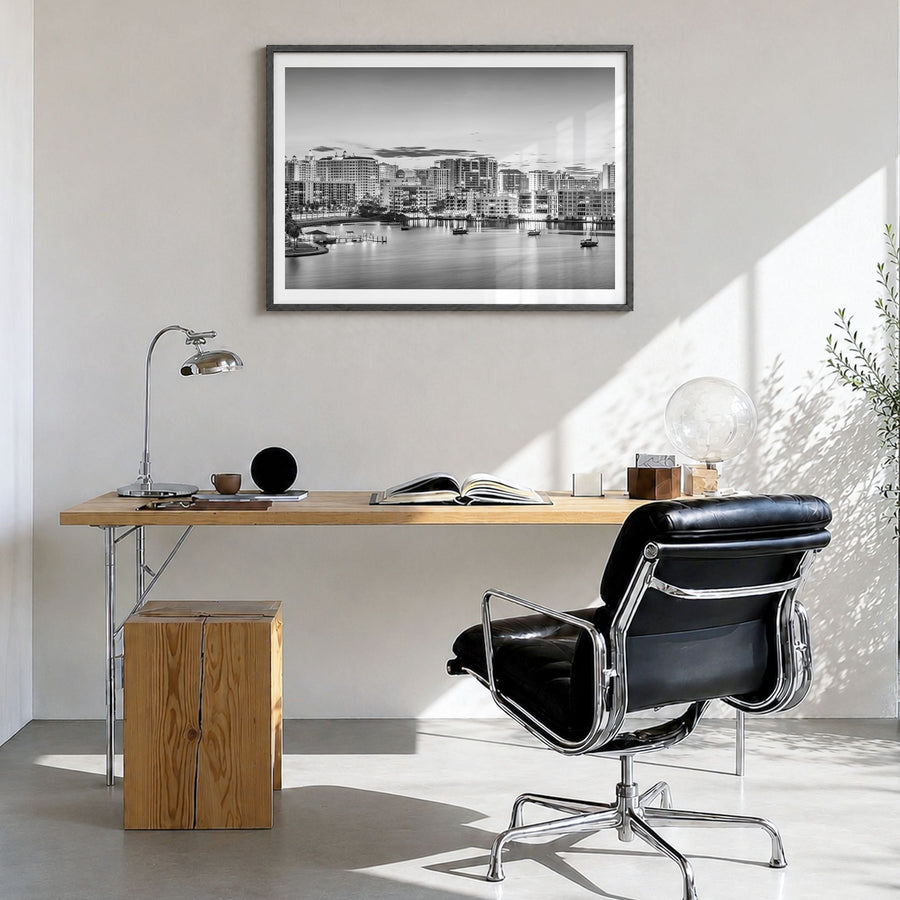 Sarasota Photo Poster in a black wood frame, hanging in a bright home office, white border