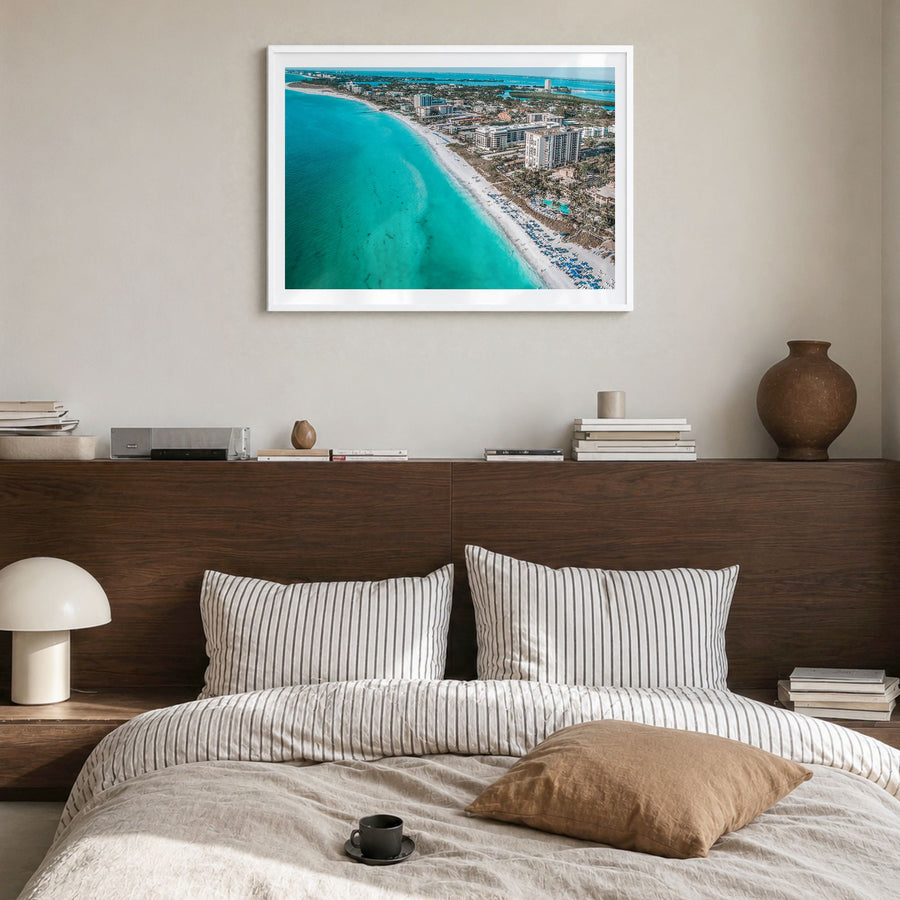 Sarasota Photo Poster in a white wood frame, hanging in a bedroom, white border