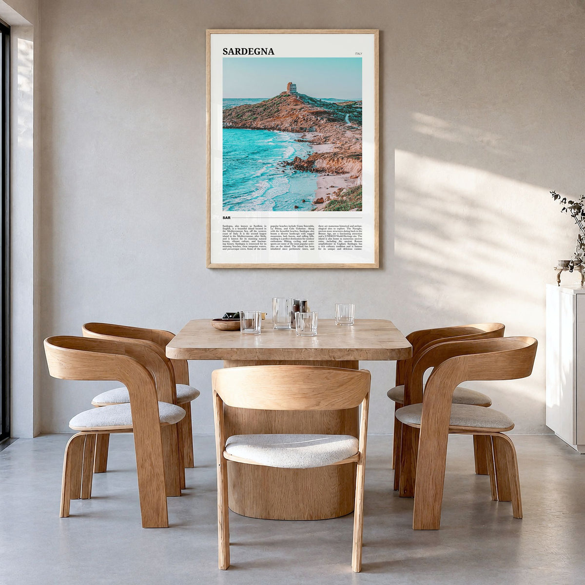 Sardegna Travel Poster in a natural wood frame, hanging in a dining room