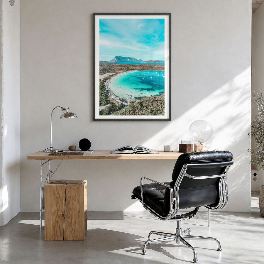 Sardinia Photo Poster in a black wood frame, hanging in a bright home office, white border