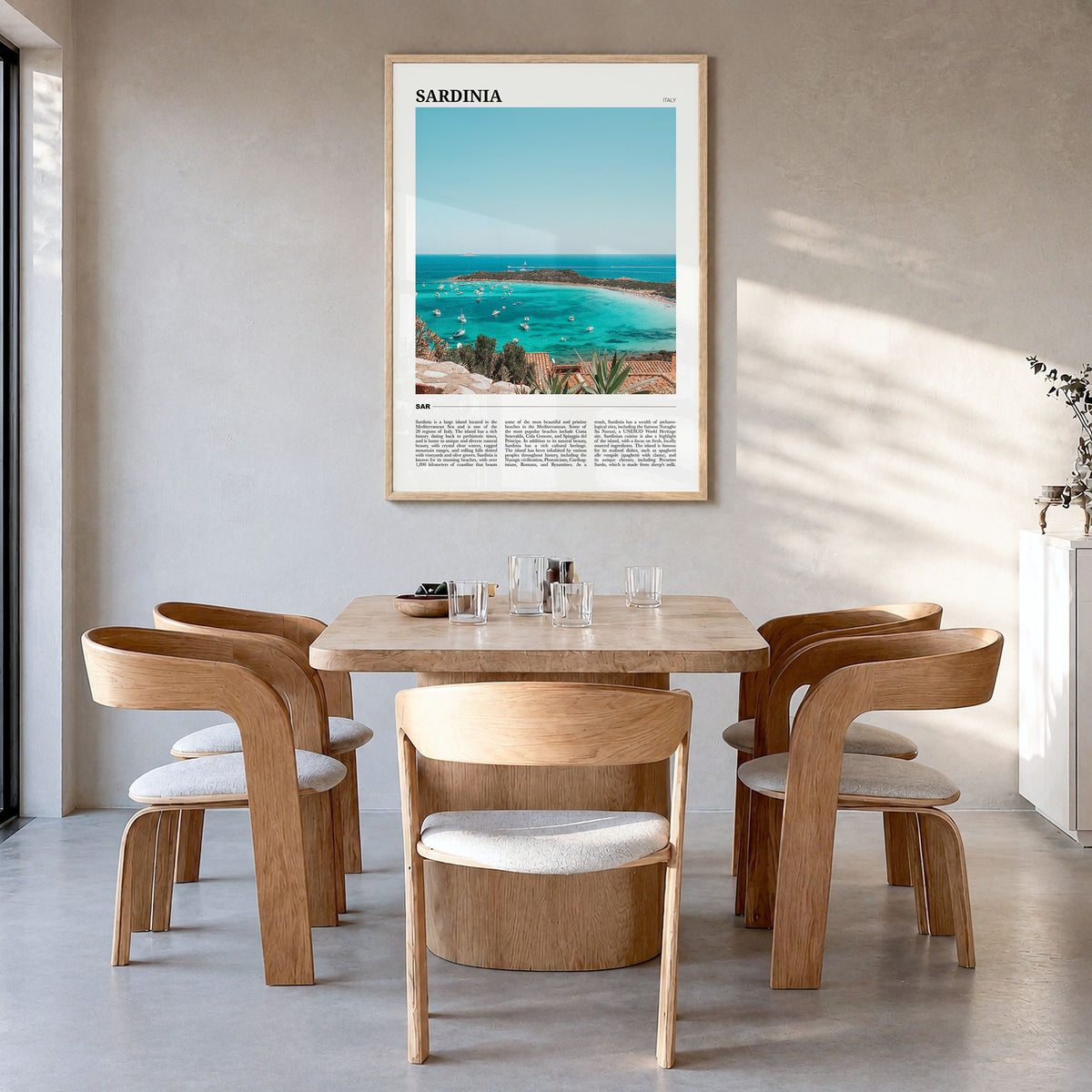 Sardinia Travel Poster in a natural wood frame, hanging in a dining room