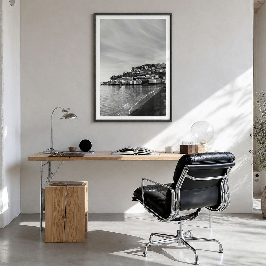Sausalito Photo Poster in a black wood frame, hanging in a bright home office, white border