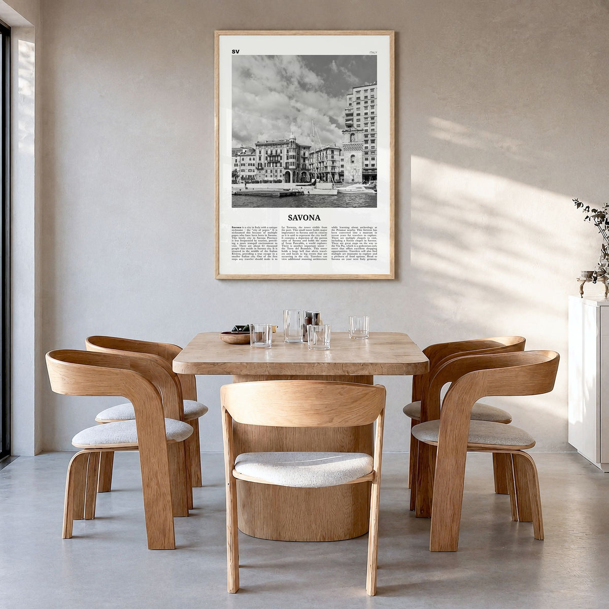 Savona Newspaper Poster in a natural wood frame, hanging in a dining room