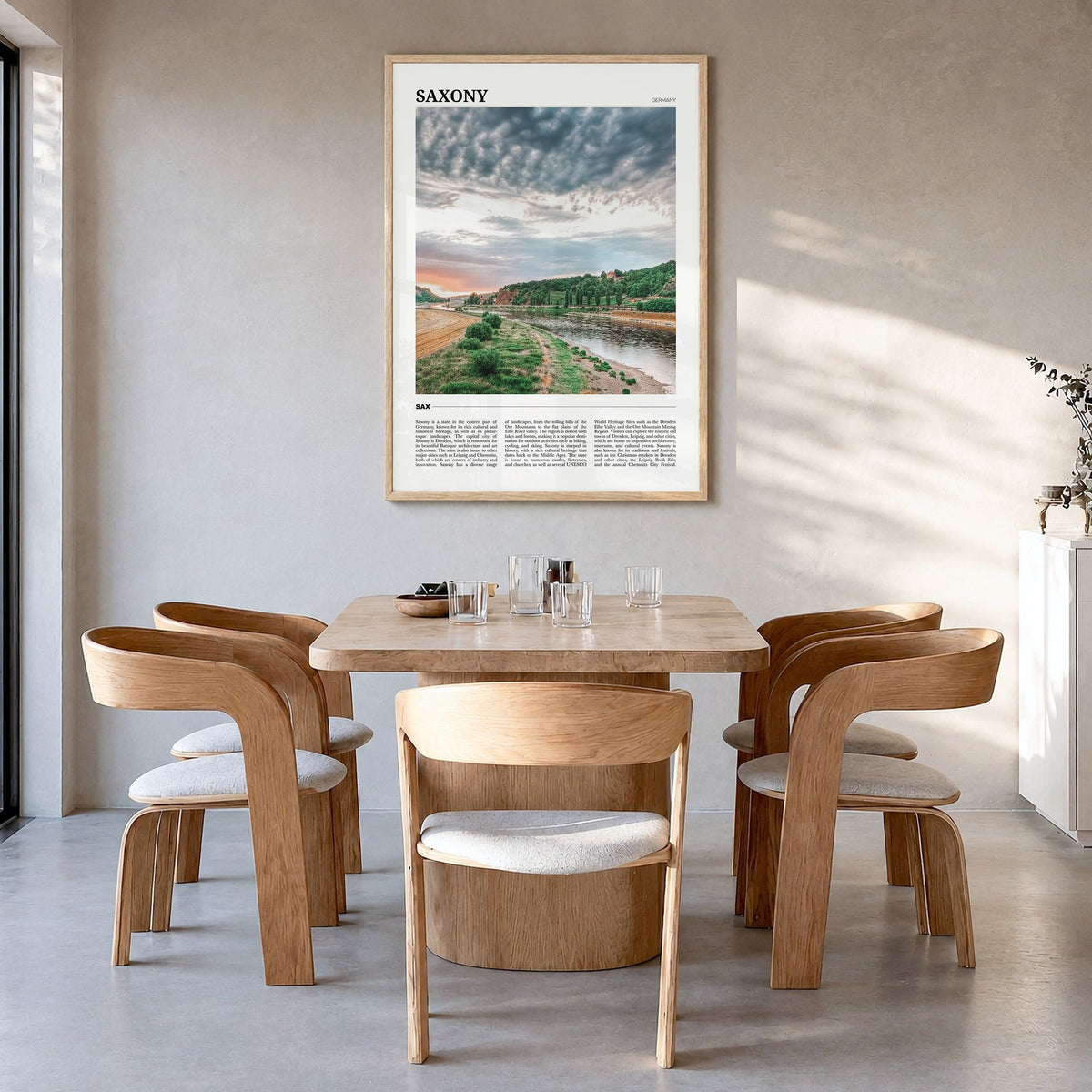 Saxony Travel Poster in a natural wood frame, hanging in a dining room