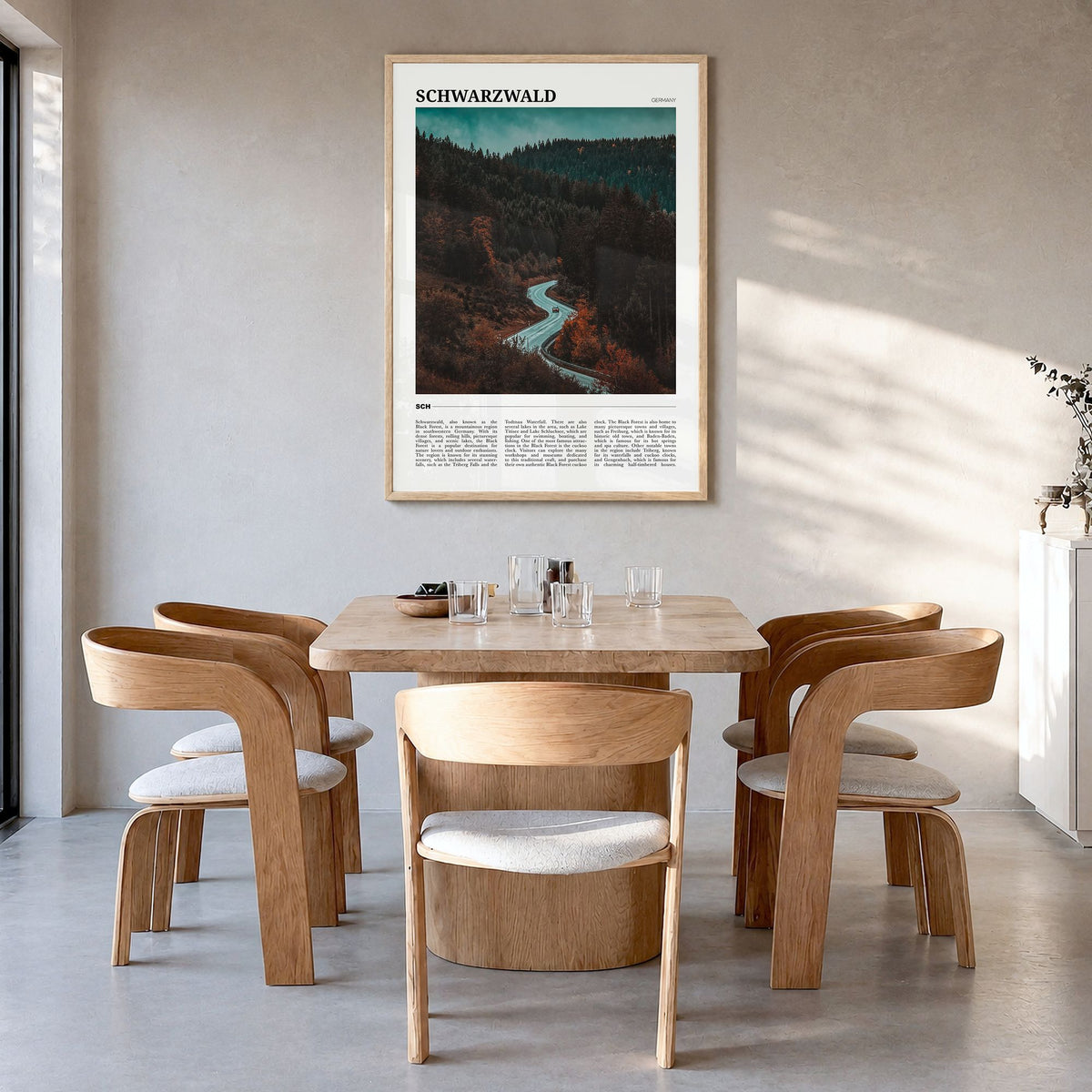 Schwarzwald Travel Poster in a natural wood frame, hanging in a dining room