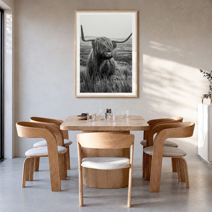 Highland Cow Photo No 1 Poster in a natural wood frame, hanging in a dining room, white border