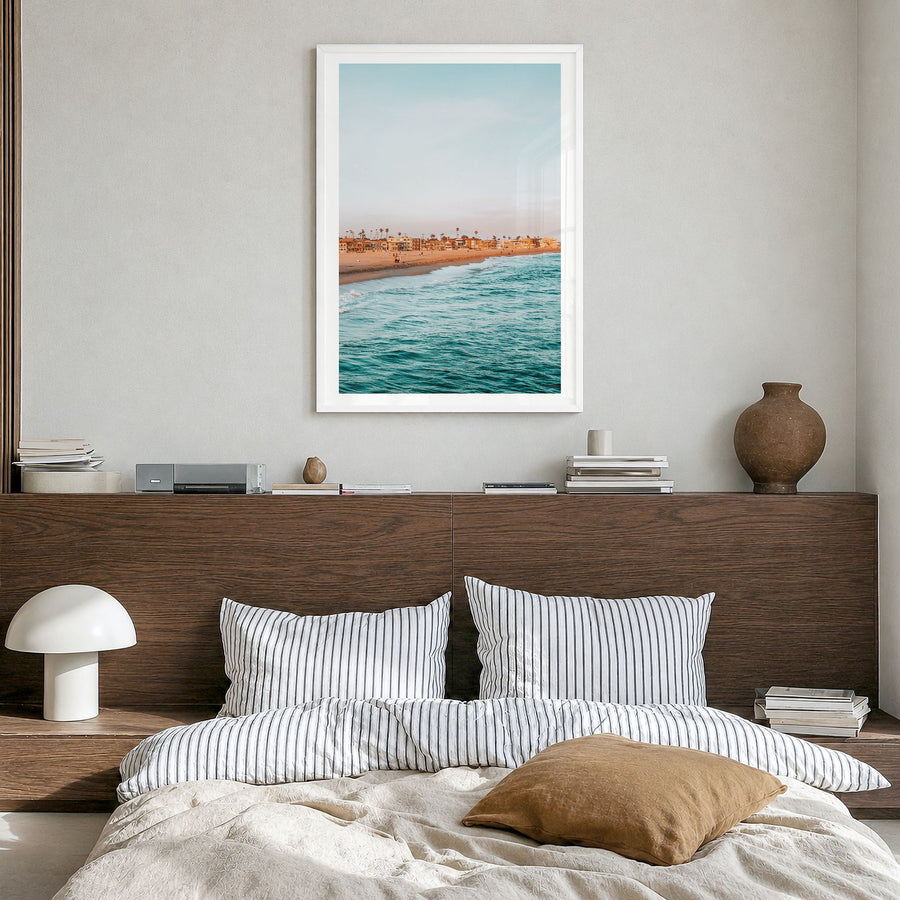 Seal Beach Photo Poster in a white wood frame, hanging in a bedroom, white border