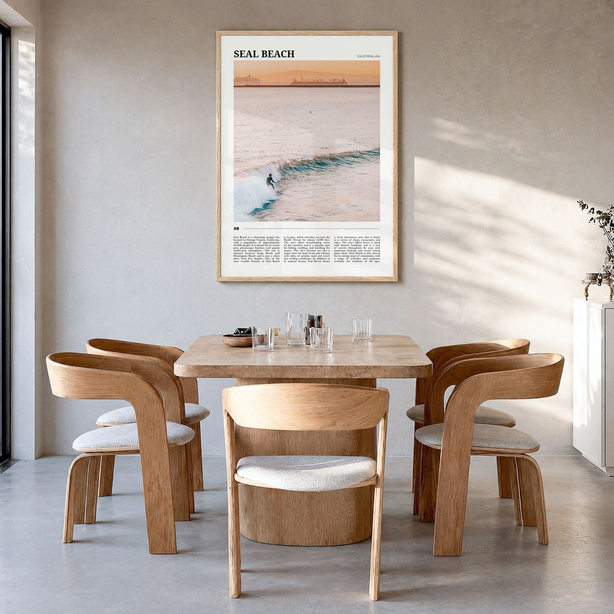 Seal Beach Travel No 1 Poster in a natural wood frame, hanging in a dining room