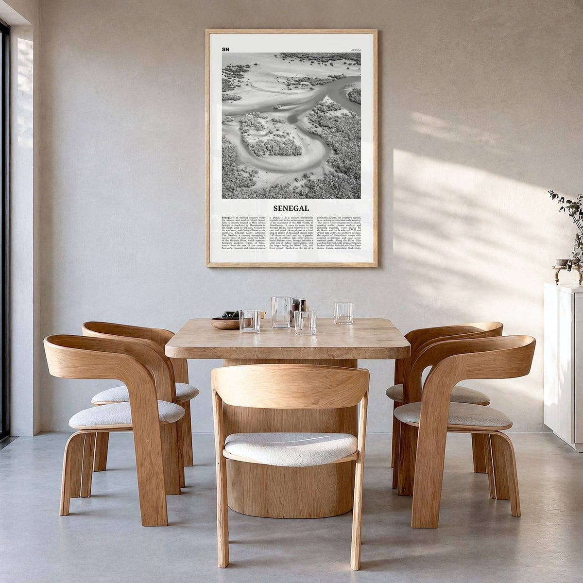 Senegal Newspaper Poster in a natural wood frame, hanging in a dining room