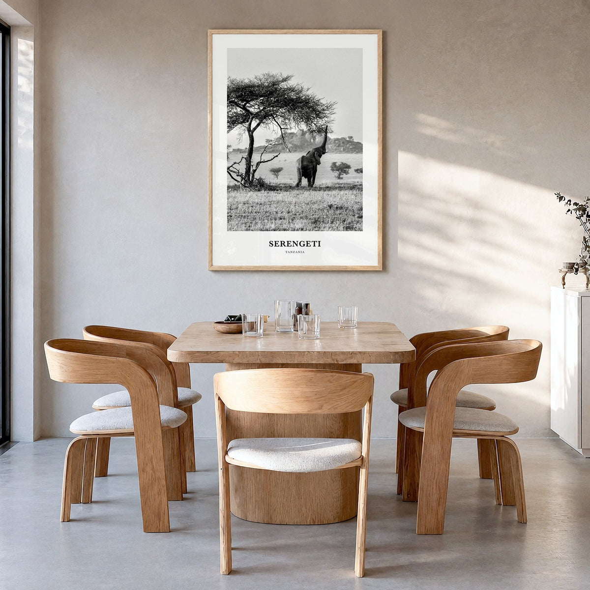 Serengeti National Park Classic Poster in a natural wood frame, hanging in a dining room