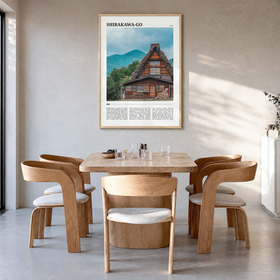 Shirakawa-go Travel Poster in a natural wood frame, hanging in a dining room