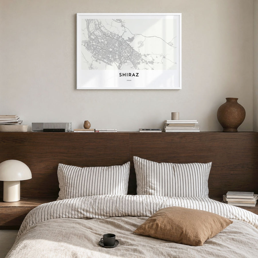 Shiraz Map Poster in a white wood frame, hanging in a bedroom