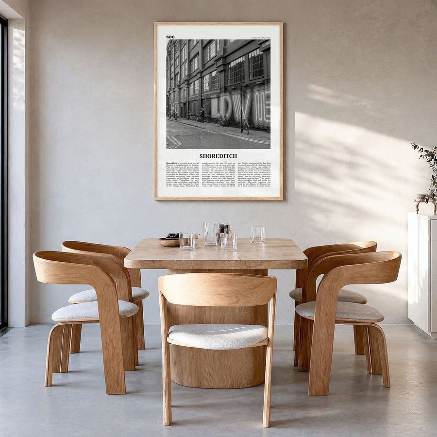 Shoreditch Newspaper Poster in a natural wood frame, hanging in a dining room
