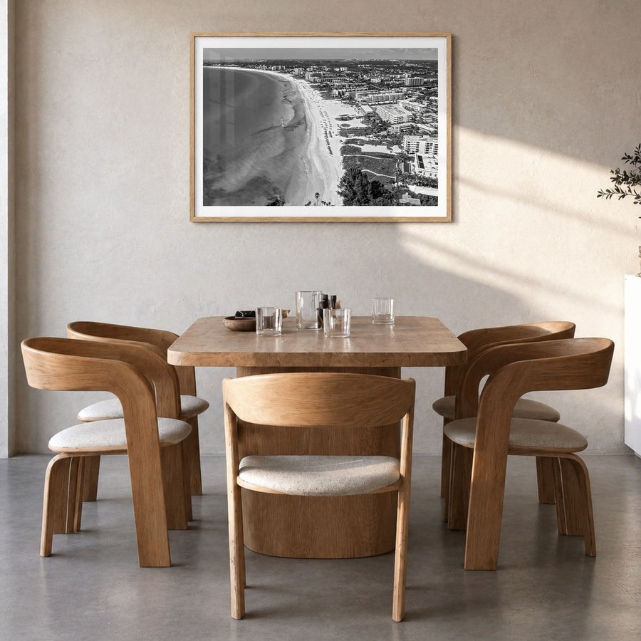Siesta Key Photo Poster in a natural wood frame, hanging in a dining room, white border