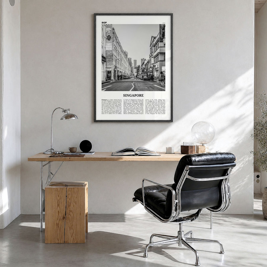 Singapore Newspaper No 2 Poster in a black wood frame, hanging in a bright home office