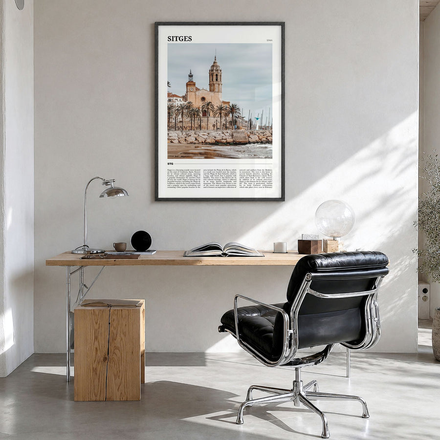 Sitges Travel Poster in a black wood frame, hanging in a bright home office