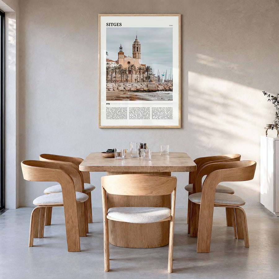Sitges Travel Poster in a natural wood frame, hanging in a dining room