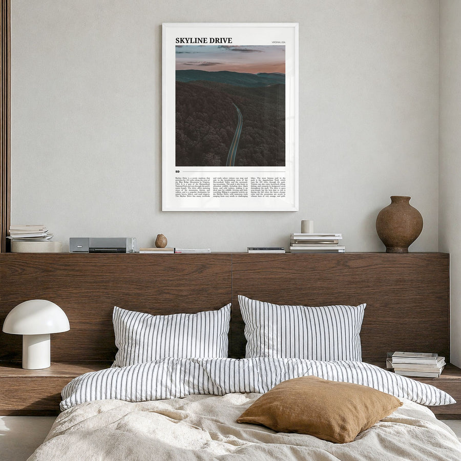 Skyline Drive Travel Poster in a white wood frame, hanging in a bedroom