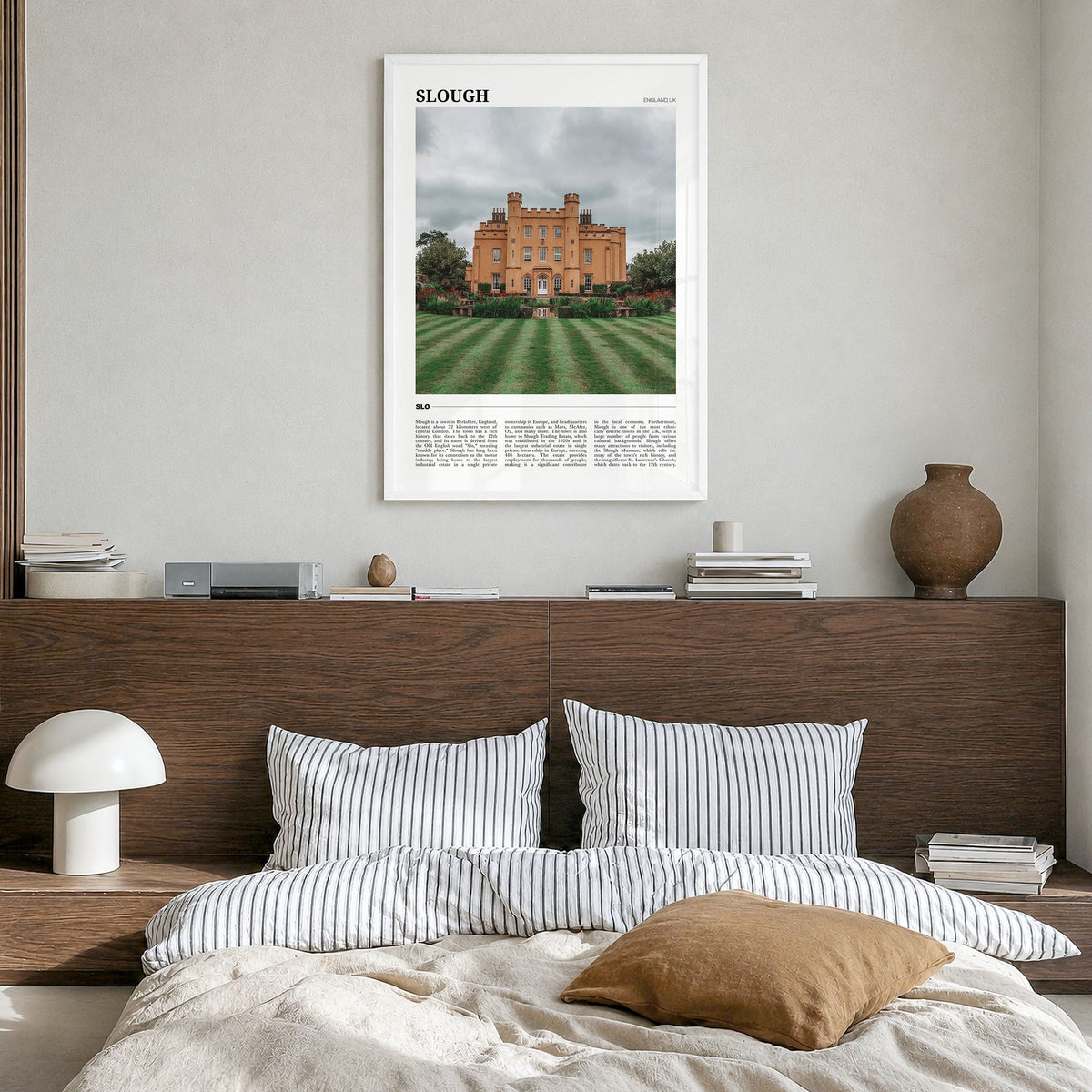 Slough Travel Poster in a white wood frame, hanging in a bedroom