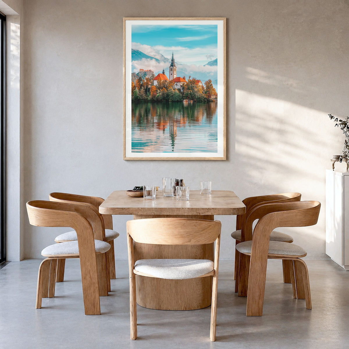 Slovenia Photo Poster in a natural wood frame, hanging in a dining room, white border