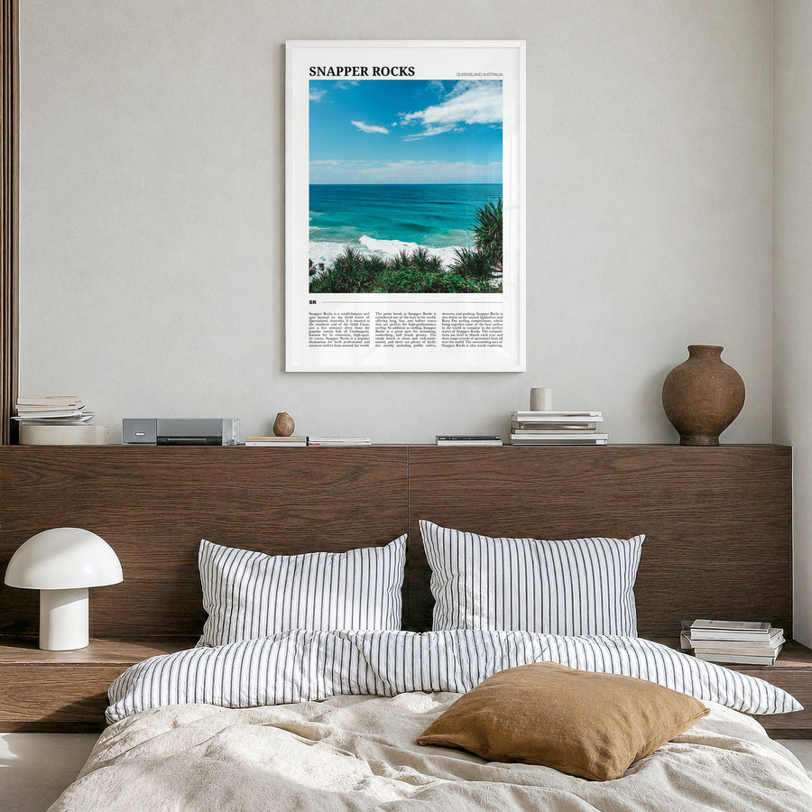 Snapper Rocks Travel Poster in a white wood frame, hanging in a bedroom