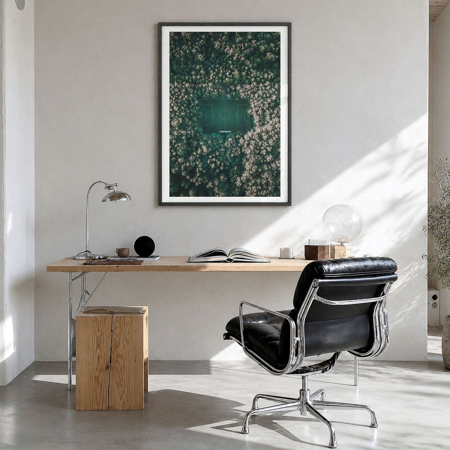 Soccer Field Photo Poster in a black wood frame, hanging in a bright home office, white border