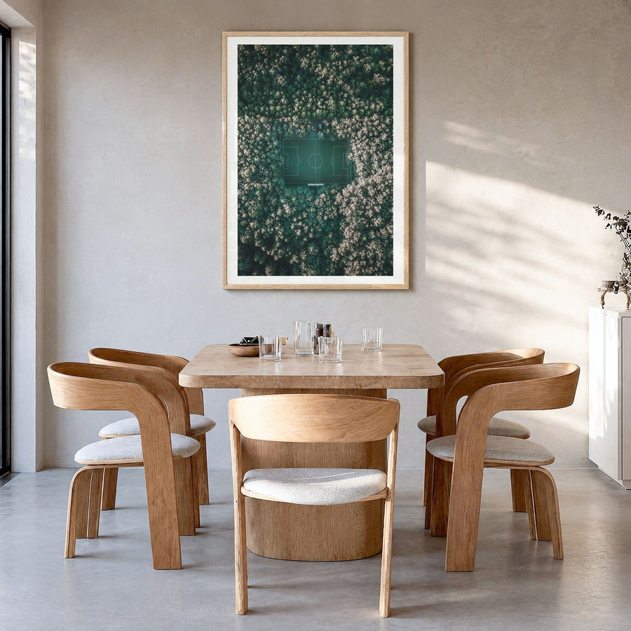 Soccer Field Photo Poster in a natural wood frame, hanging in a dining room, white border