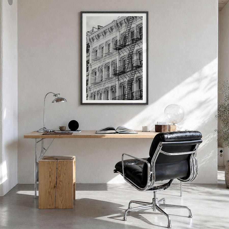 SoHo, New York City Photo Poster in a black wood frame, hanging in a bright home office, white border