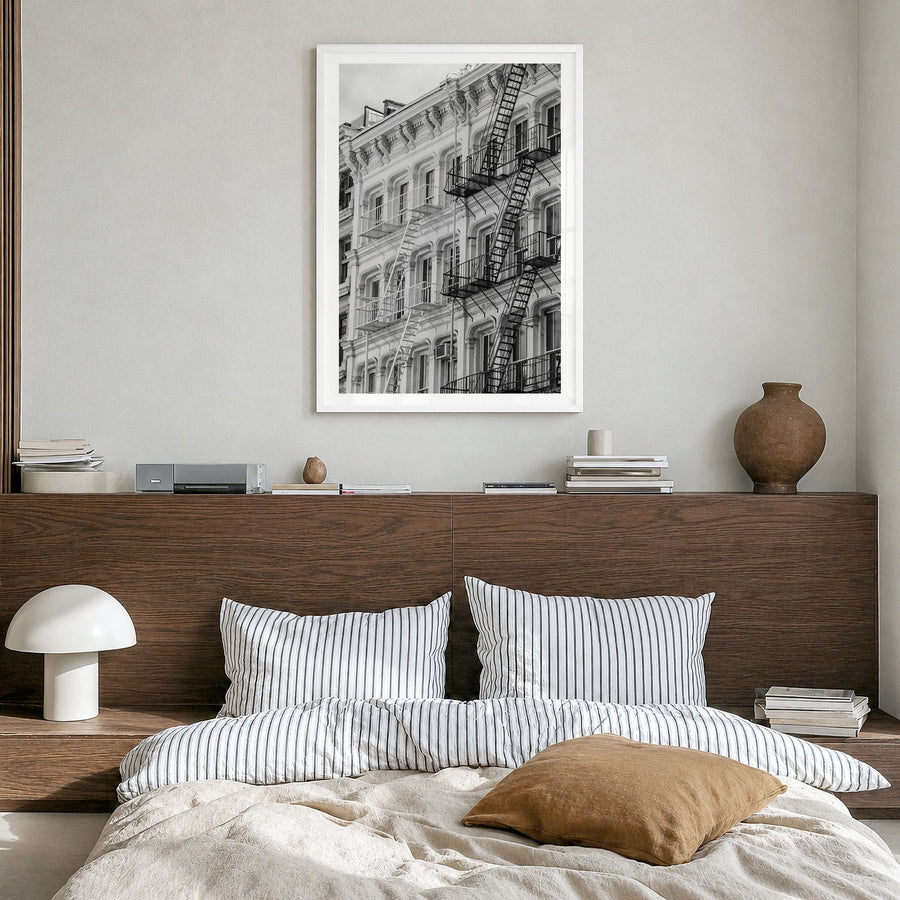 SoHo, New York City Photo Poster in a white wood frame, hanging in a bedroom, white border