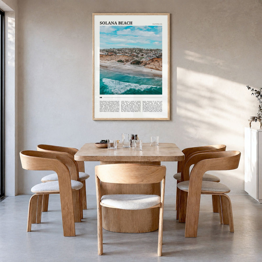 Solana Beach Travel Poster in a natural wood frame, hanging in a dining room
