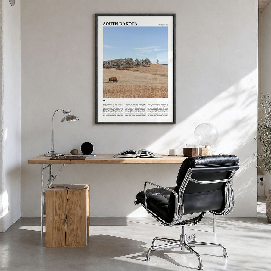 South Dakota Travel Poster in a black wood frame, hanging in a bright home office