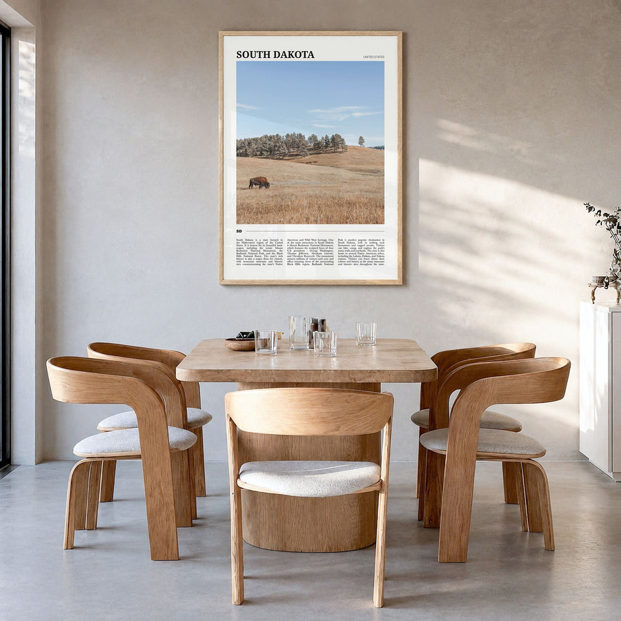 South Dakota Travel Poster in a natural wood frame, hanging in a dining room