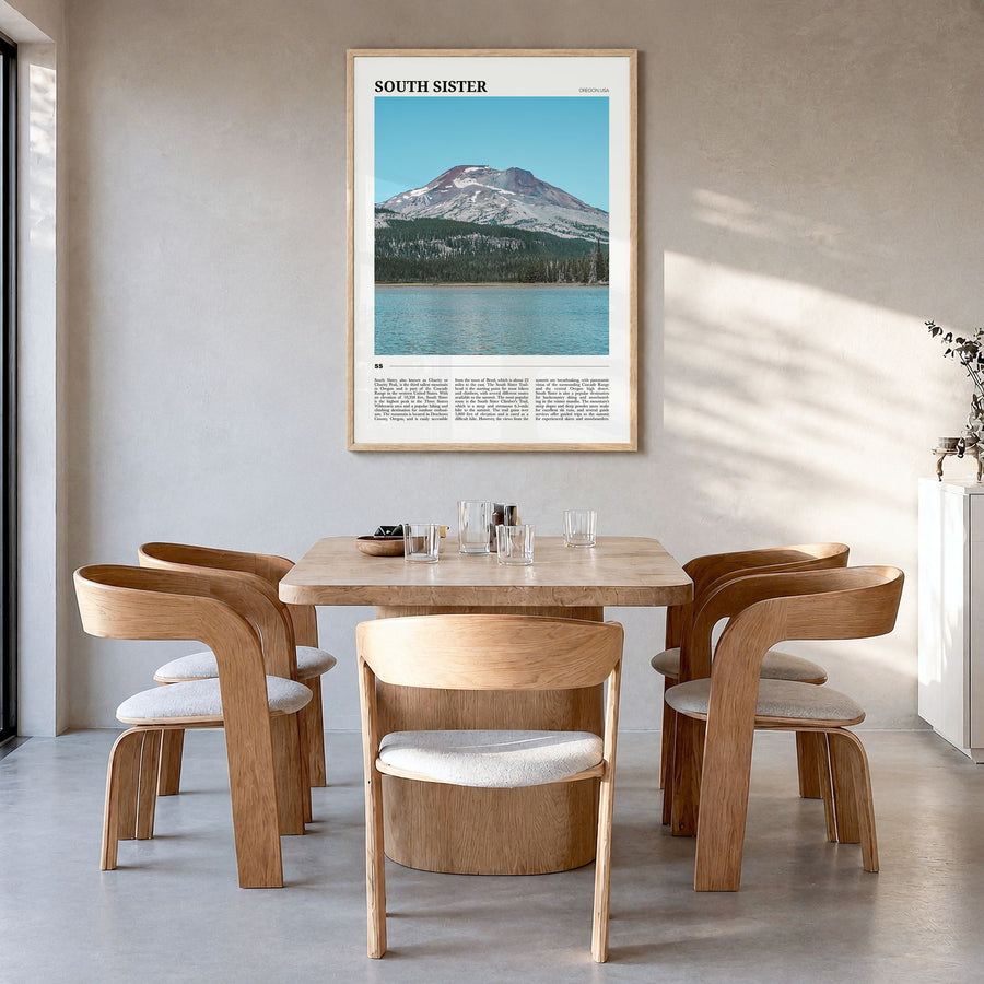 South Sister Travel Poster in a natural wood frame, hanging in a dining room