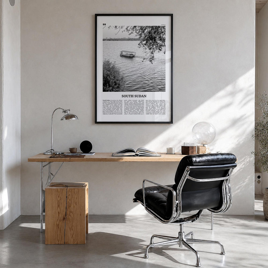 South Sudan black & white newspaper poster of Africa – vertical wall art in black wood frame, hanging on wall