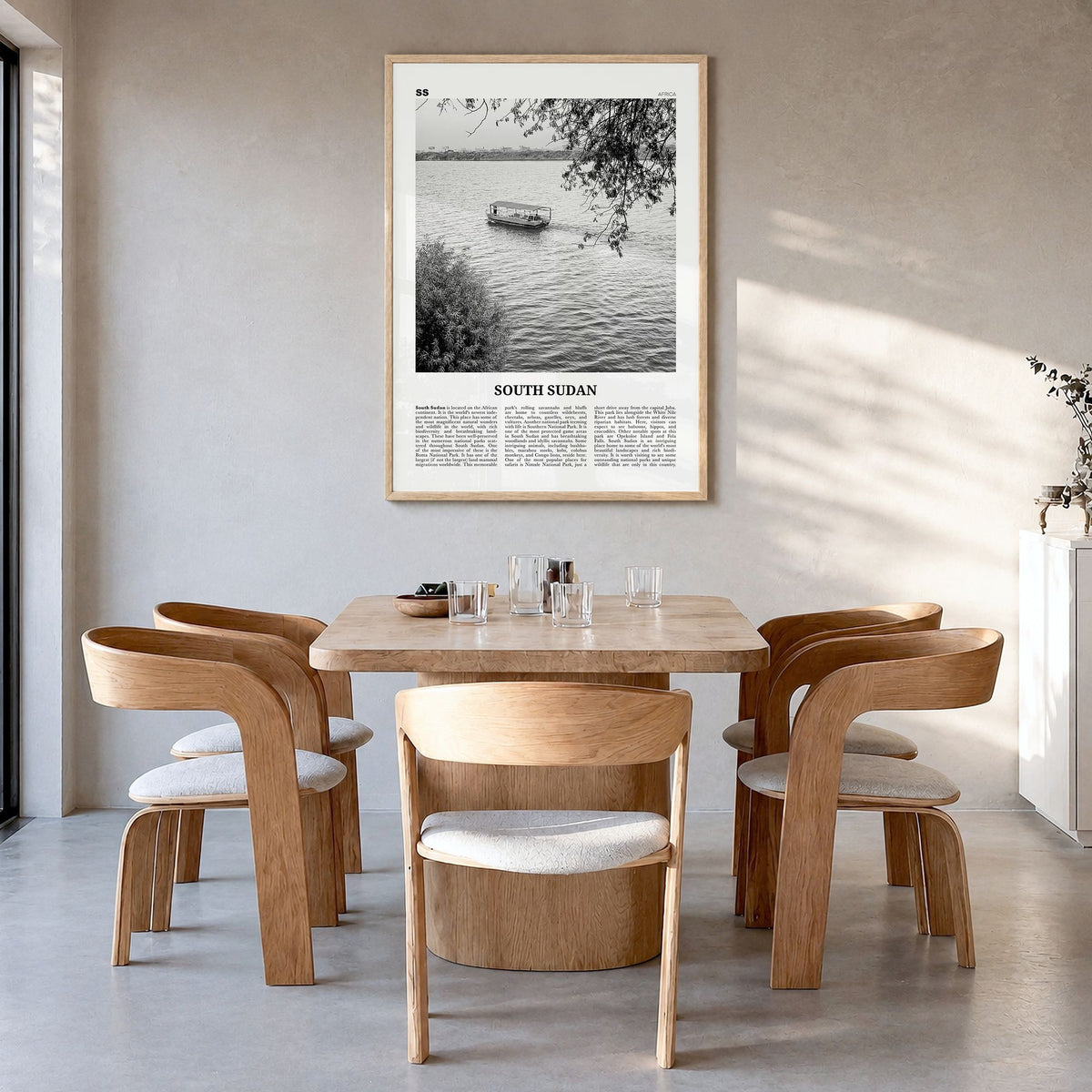 South Sudan Newspaper Poster in a natural wood frame, hanging in a dining room