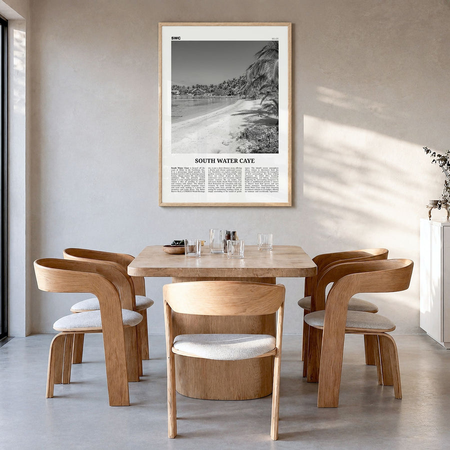 South Water Caye Newspaper Poster in a natural wood frame, hanging in a dining room