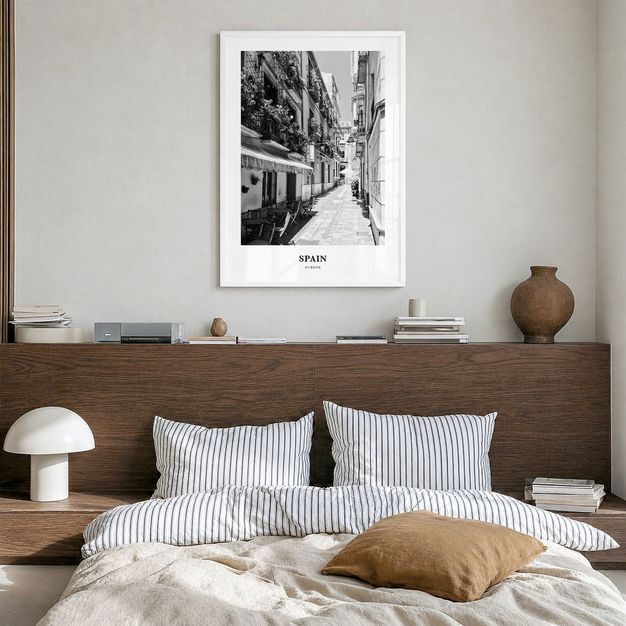 Spain Classic No 3 Poster in a white wood frame, hanging in a bedroom