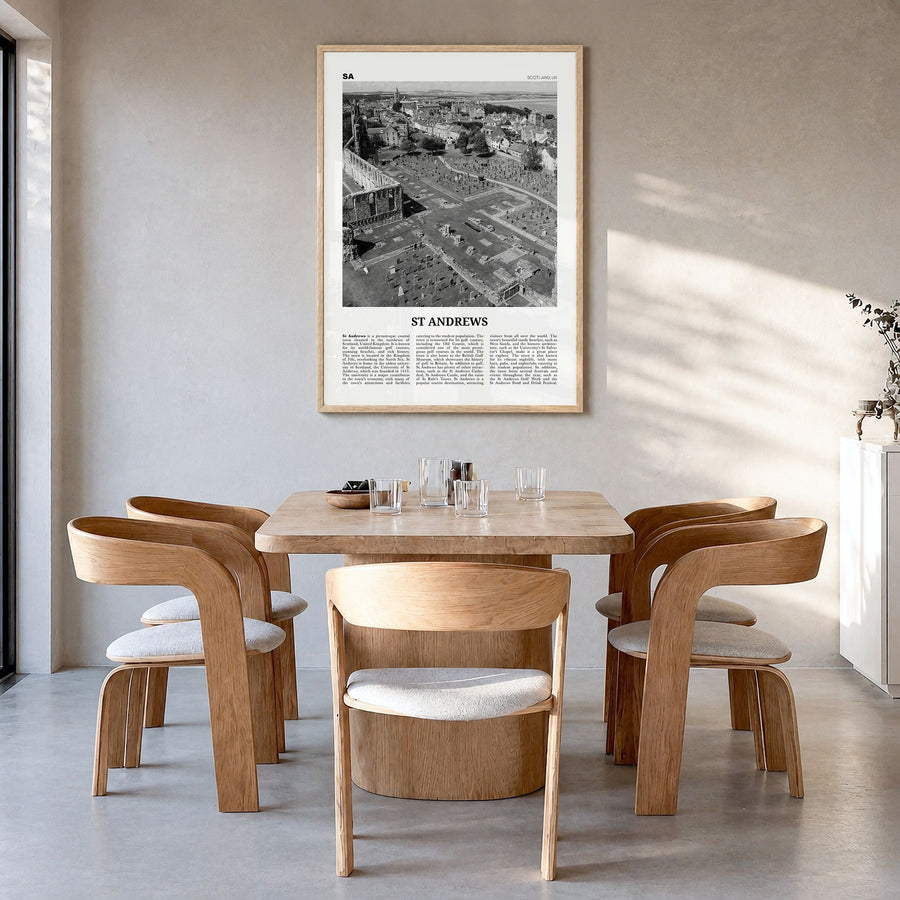 St. Andrews Newspaper Poster in a natural wood frame, hanging in a dining room