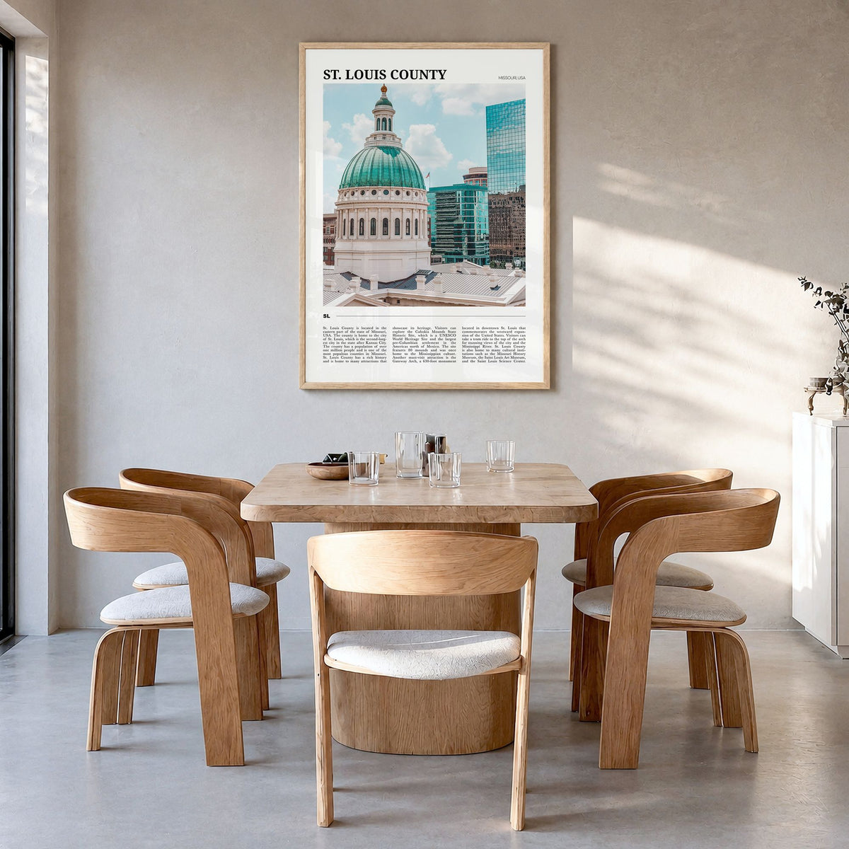 St. Louis County Travel Poster in a natural wood frame, hanging in a dining room