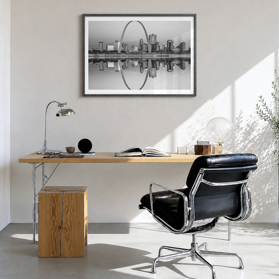 St. Louis Photo Poster in a black wood frame, hanging in a bright home office, white border