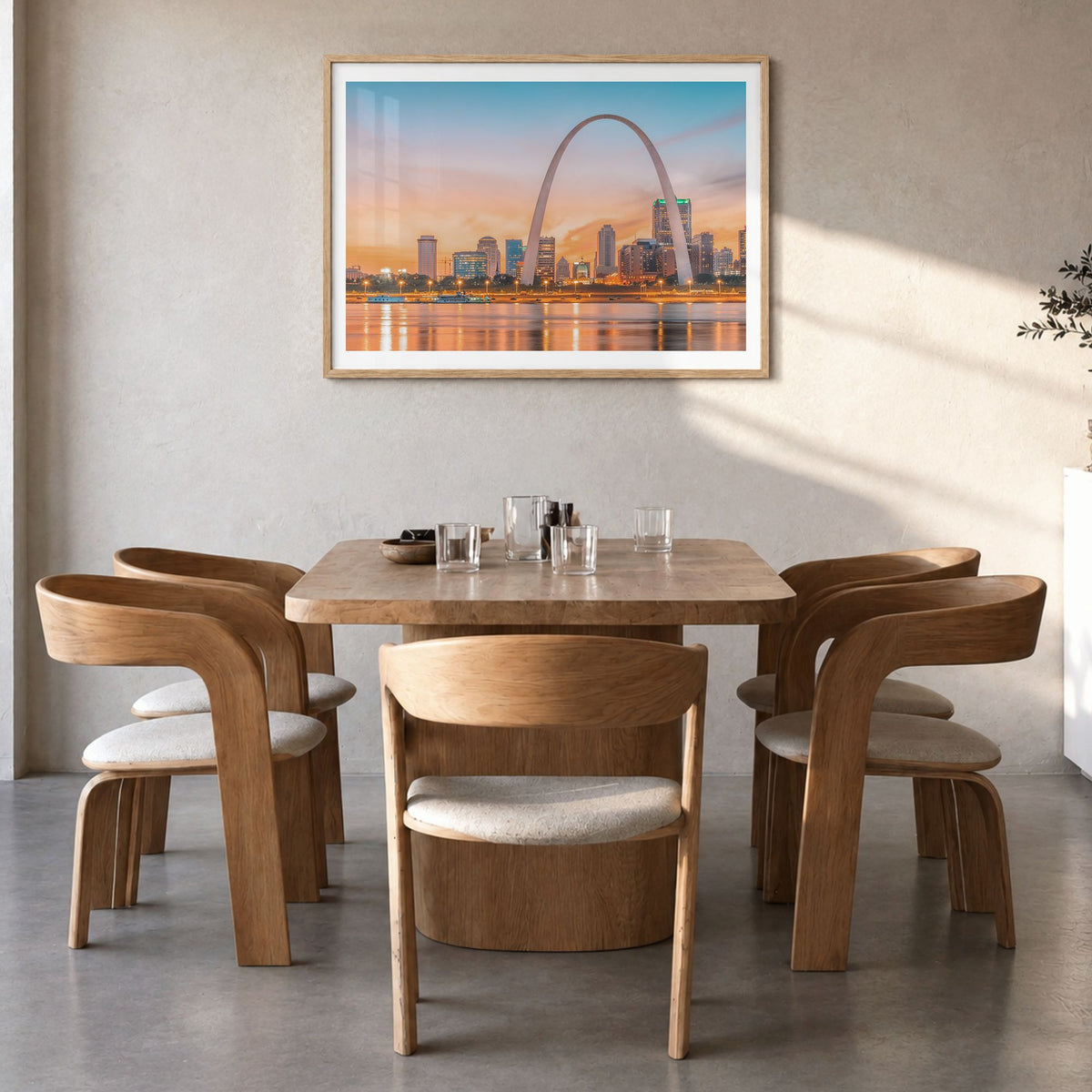 St. Louis Photo Poster in a natural wood frame, hanging in a dining room, white border