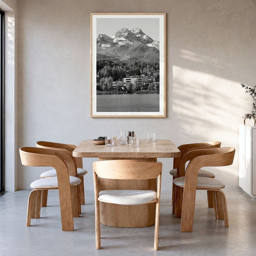 St. Moritz Photo Poster in a natural wood frame, hanging in a dining room, white border